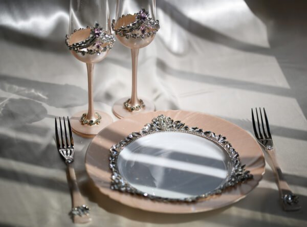 Grace Classic handcrafted luxury wedding set featuring rose gold champagne flutes with pink crystal crown rim, crystal-embellished plate with floral accents, and matching rose gold forks