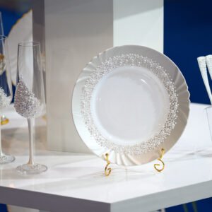 Pearl Classic handcrafted luxury wedding set featuring white pearl-encrusted champagne flutes, handpainted white plate with pearl border, and elegant white pearl-adorned forks on display